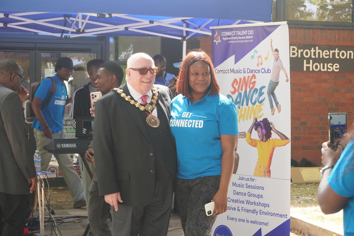 Ceremonial Mayor Robin Garrido and team members smiling by the Connect Talent Music and Dance banner